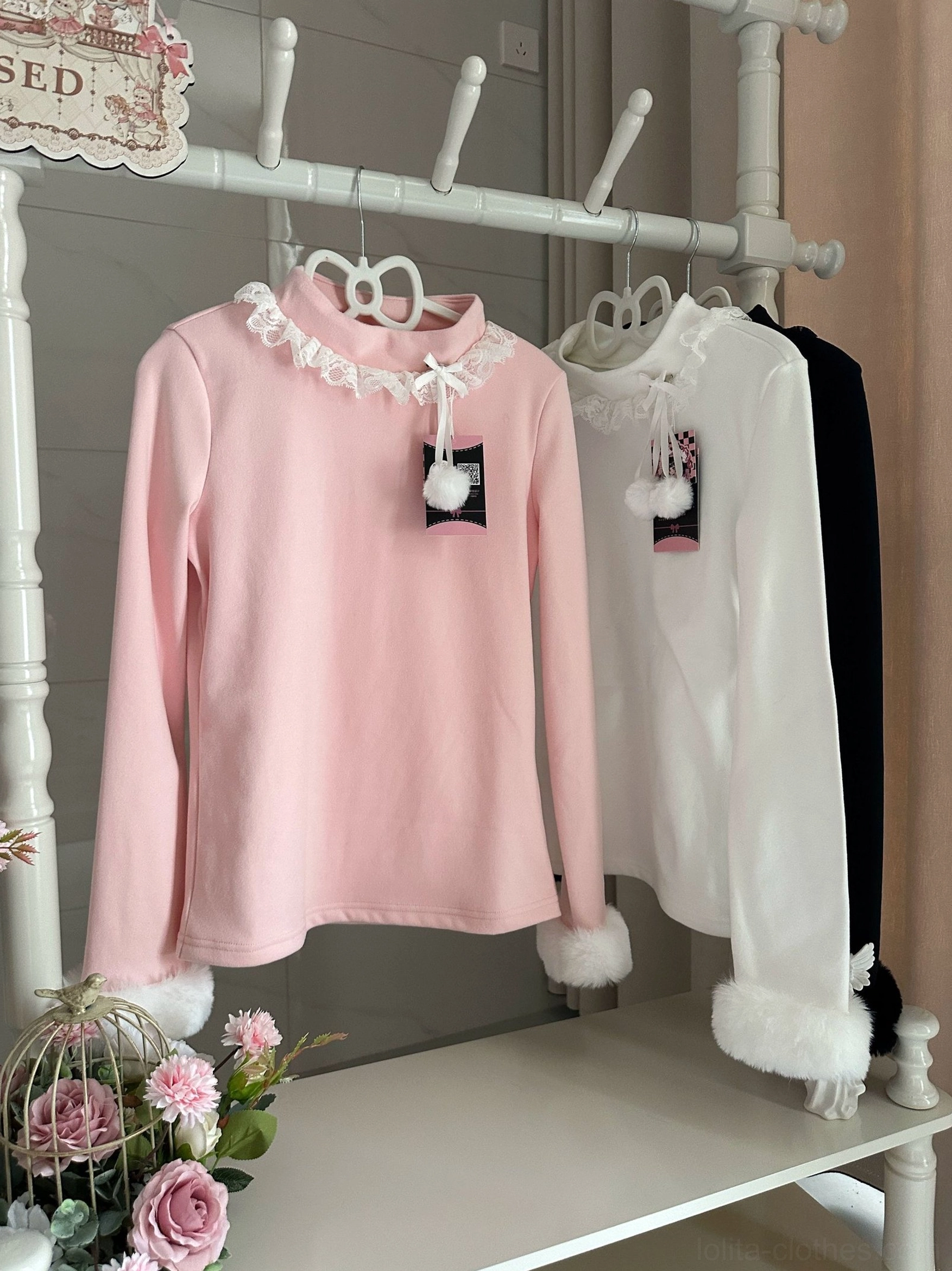 Pink Lolita winter base layer innerwear with fuzzy faux fur cuffs and lace-trimmed turtleneck on boutique clothing display rack with rose floral decorations