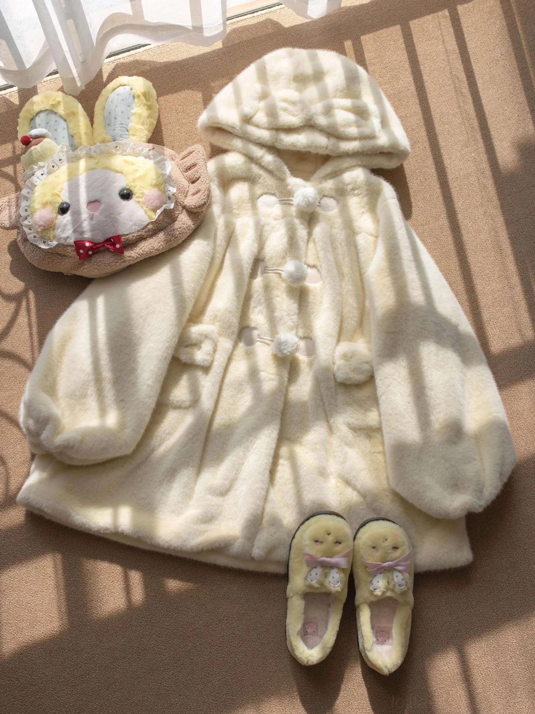 Cream yellow lolita winter thickened fluffy overcoat flat lay display paired with matching bunny plush bag and yellow loafers, bear ear hood and pom-pom buttons