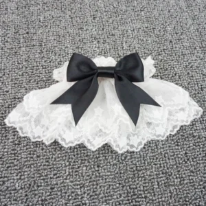 Single lolita wrist cuff with star-patterned lace edging and black satin bow detail close-up flat lay