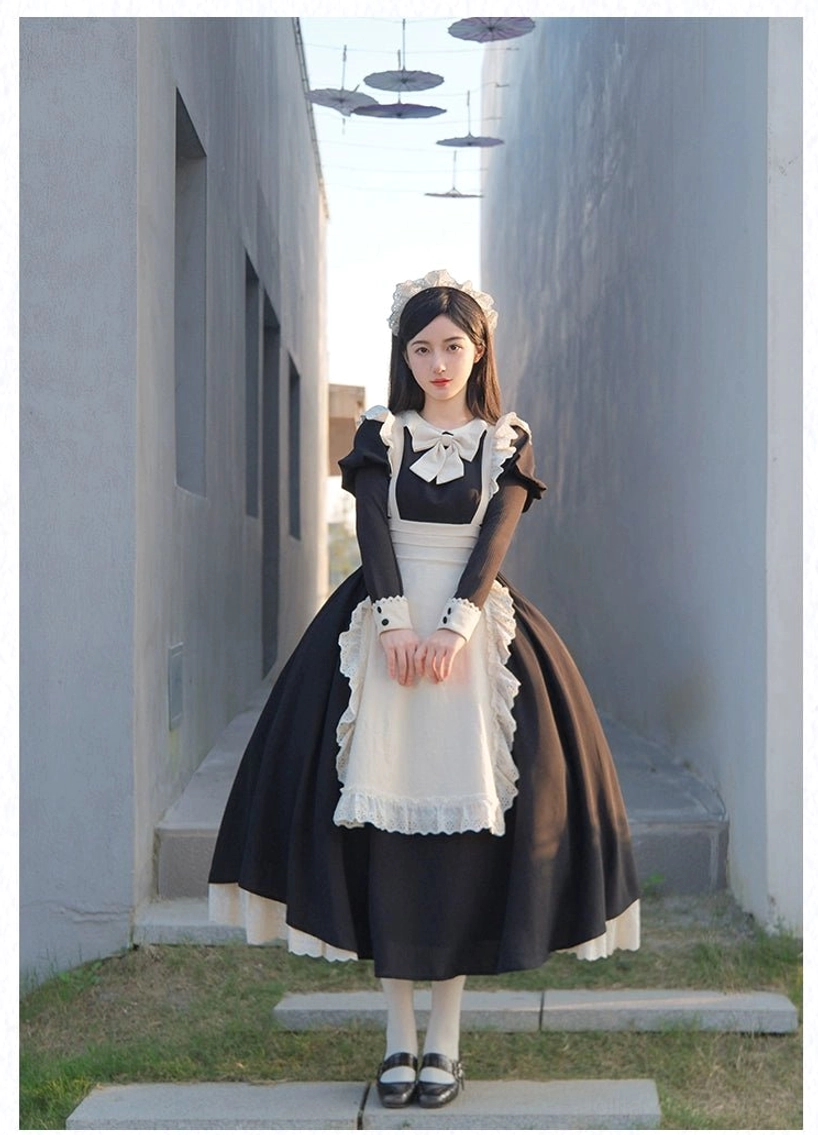 Long skirt maid lolita dress with full lace apron and long sleeves on dark-haired model standing outdoors