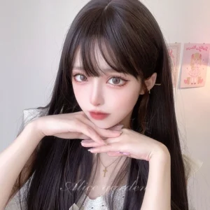 Jet black long straight lolita wig with air bangs and cross pendant necklace closeup frontal shot on female model wearing white lace camisole