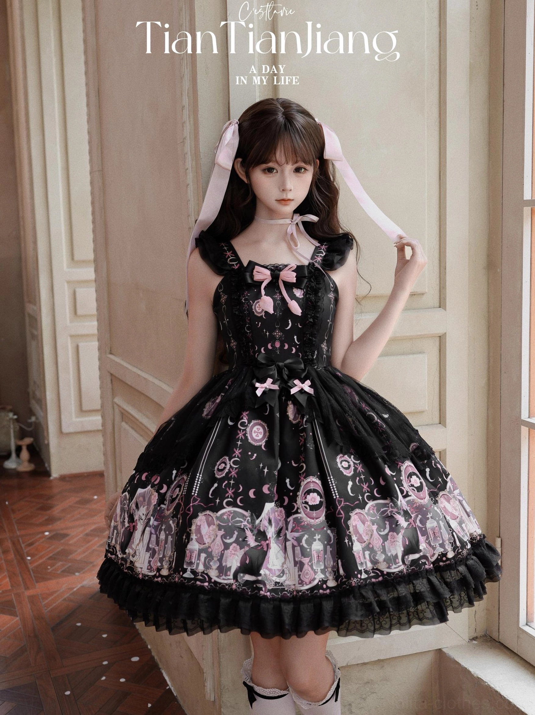 Lunar Cat Crown Sweet Lolita Black JSK Jumper Skirt - Front Close-up Eye Level Portrait Showing Angel Cat Moon Stars Print and Pink Bow Bodice Accent