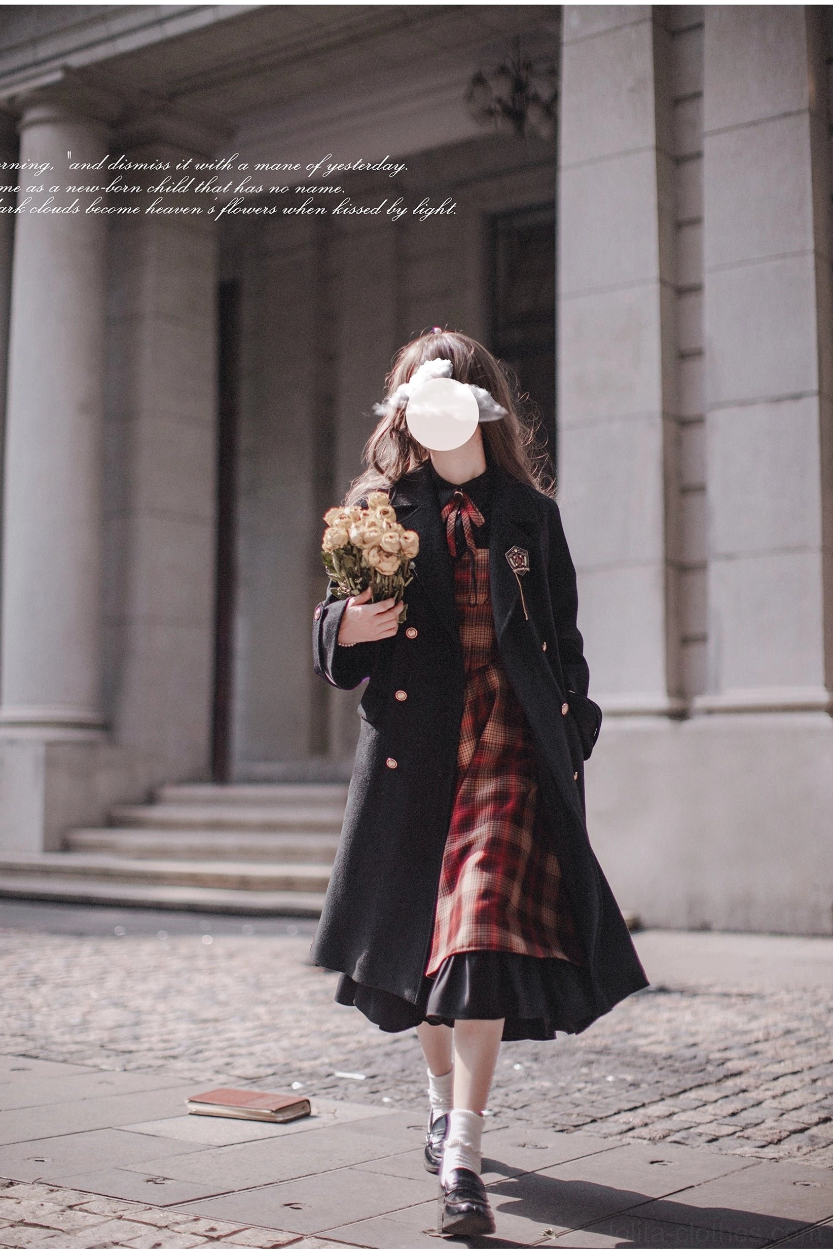 Madeleine classic lolita JSK suit with red plaid jumper skirt, black long-sleeve blouse, and black double-breasted wool coat - full body side view on model walking through historic European stone building square