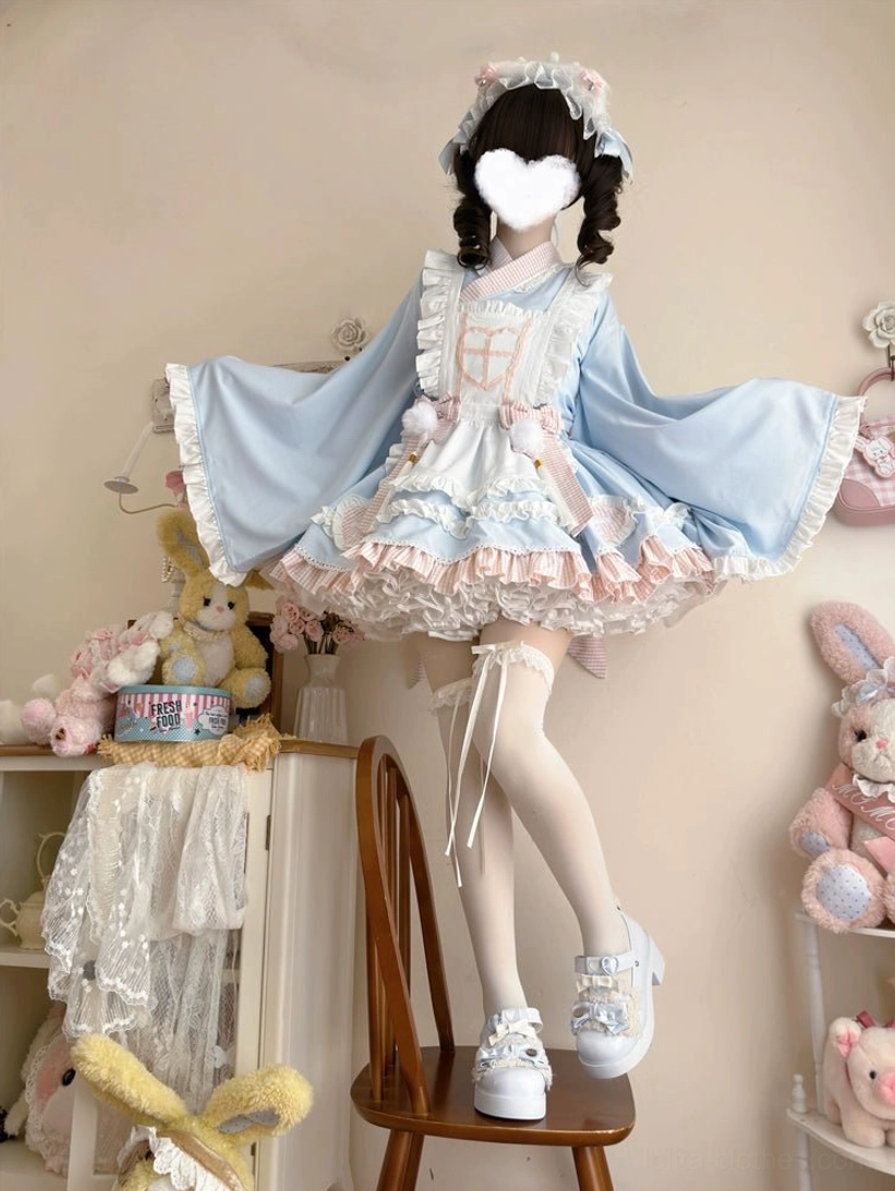 Maid lolita dress set apron detail shot showing heart-shaped embroidery pom-pom and tassel bow decorations