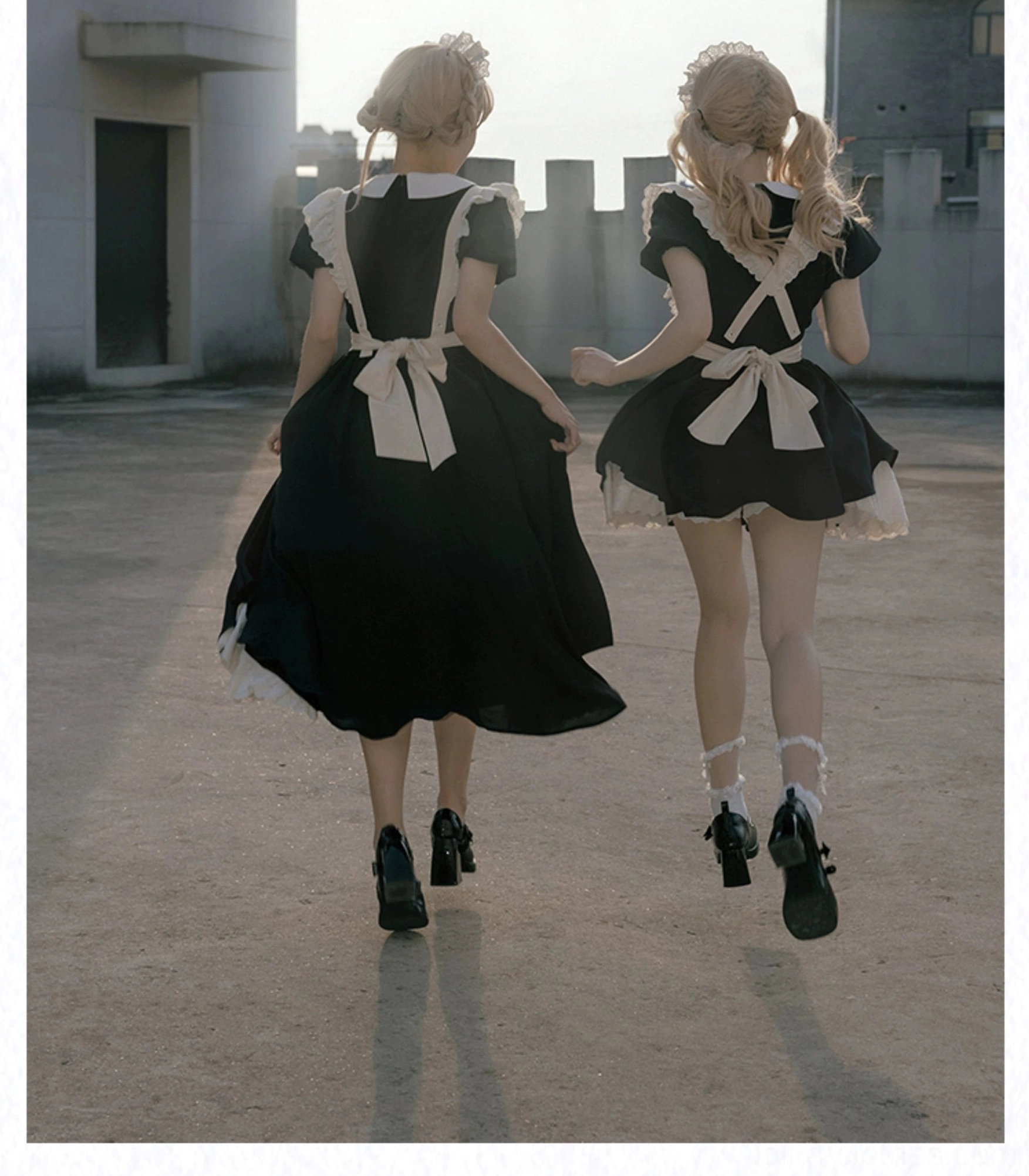 Maid lolita OP dress back view showing large back waist bow and solid black design with back strap