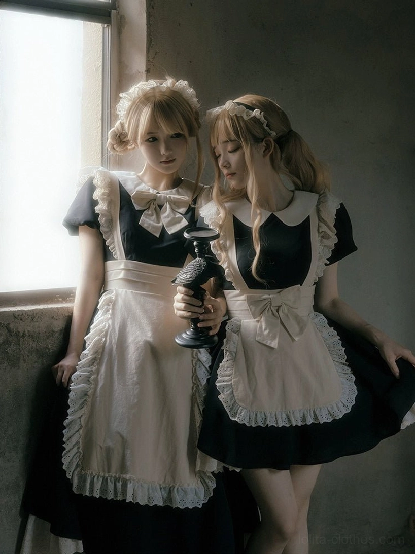 Classic black and white maid lolita dress with lace-trimmed apron and Peter Pan collar on models by window