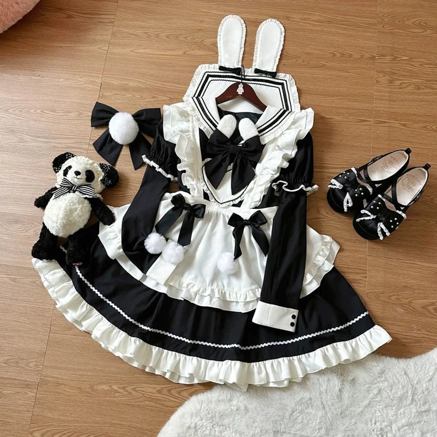 Detachable apron component detail shot showing ruffled edges, pom-pom trim, bow accents, and attachment mechanism for styling flexibility