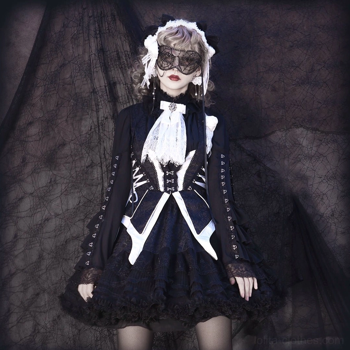 Maid-style gothic lolita ensemble featuring black dress with white skeleton-pattern corset trim details, white ruffled skirt hem, white maid hairband, and lace mask accessories