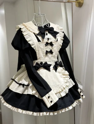 Long-sleeve maid lolita apron OP dress hung on metal hanger displaying full design with button cuffs and black bow embellishments