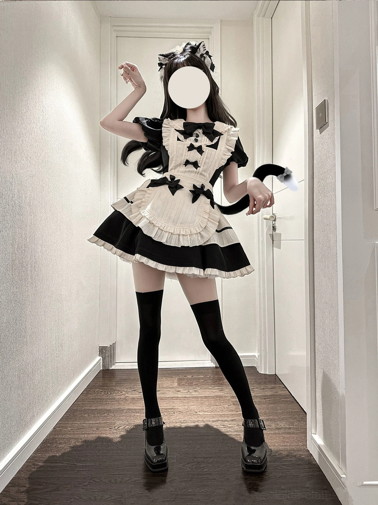 Side profile view of maid lolita apron dress on faceless model showing silhouette layered ruffled skirt hem and black bow decorated apron design
