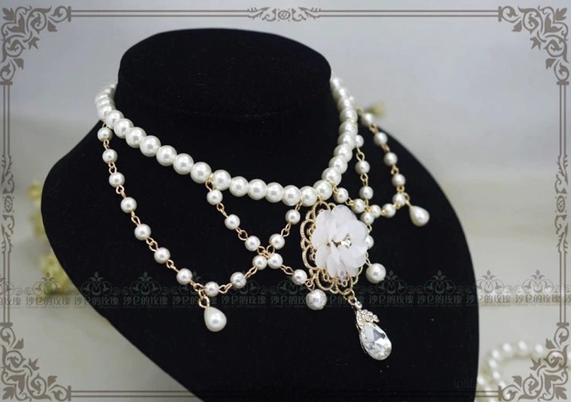 Close-up detail of Manor Ball II cameo necklace pearl strand texture and golden metal framework showing quality construction and vintage-inspired craftsmanship