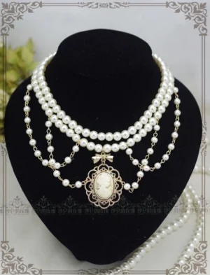 Manor Ball II vintage cameo pearl necklace featuring multi-layer white pearl strands with golden brown portrait pendant and delicate bow tie accent displayed on black velvet jewelry stand