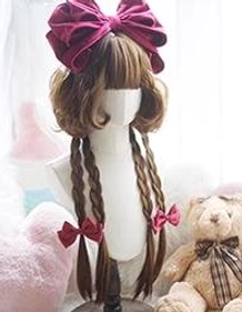 Maple sugar brown lolita cosplay wig with short curly hair, small braids with burgundy bows, compact display on plush background