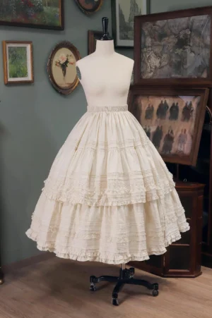 Light Apricot Classic Lolita Tiered Skirt with Apricot Lace displayed on dress form in vintage gallery setting, featuring multi-layered ruffled lace trims and high elastic waistband with voluminous flared silhouette