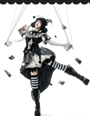 Marionette themed Gothic Lolita performance costume with puppet strings attached wrists, ruffled bloomers trim, striped socks, dynamic front pose with floating playing card props