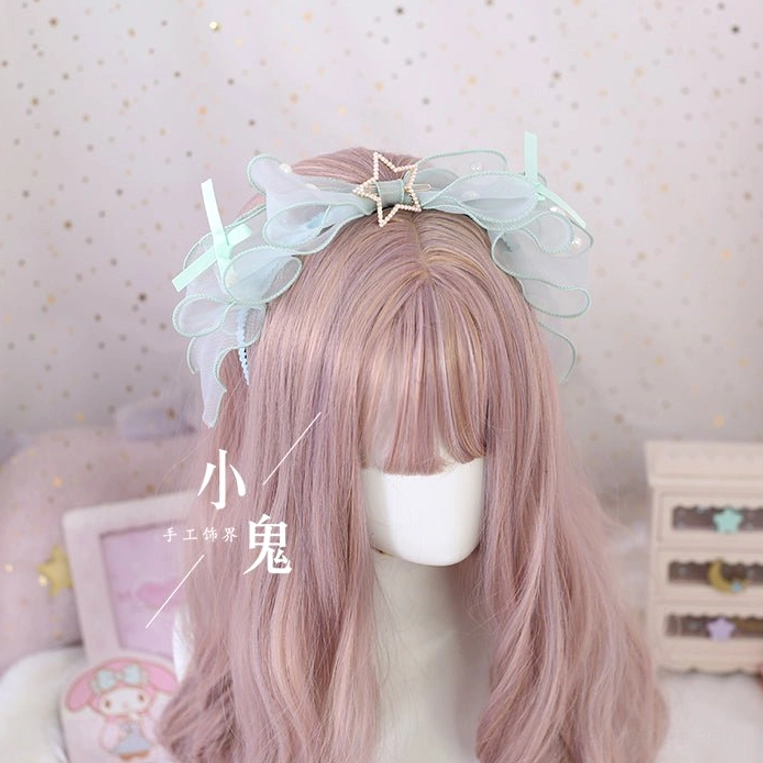 Mint green lolita bow hair clip with soft ruffled mesh and star metal ornament front straight view on mannequin