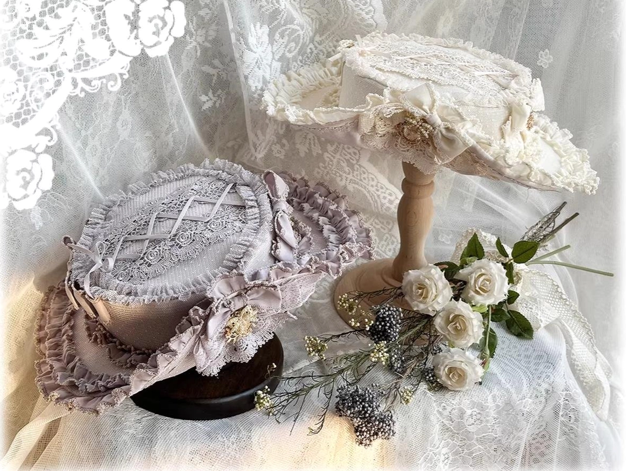 Ivory top hat with matching lace ruffled trims and decorative details, flat lay product photography with fresh flower accents