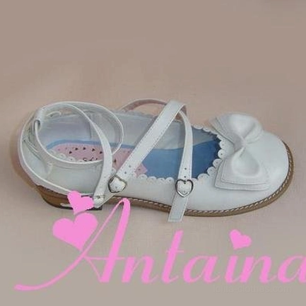 Matte white lolita Mary Jane shoes with soft finish, dual ankle buckle straps, decorative toe bow ornament, and classic block heel silhouette