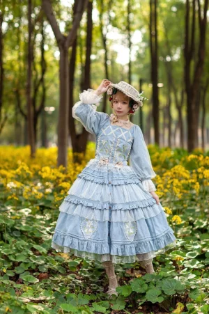 Sky blue melaleuca lily embroidered country lolita dress set with square neckline bishop sleeves tiered ruffled skirt and matching flower straw hat worn outdoors in wildflower field