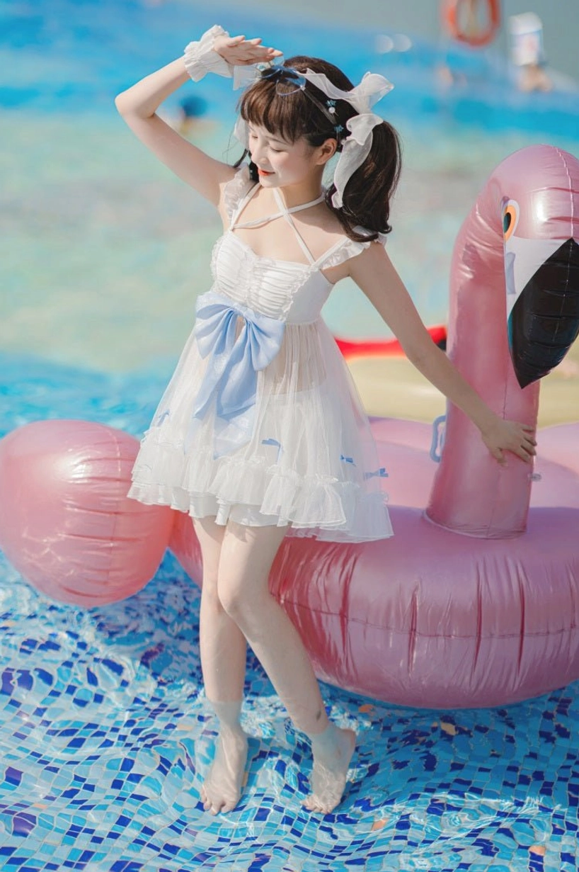 Mermaid dreams lolita swimwear two-piece three-quarter front view outdoor pool setting white base sky-blue bow ruffled tulle skirt spaghetti straps