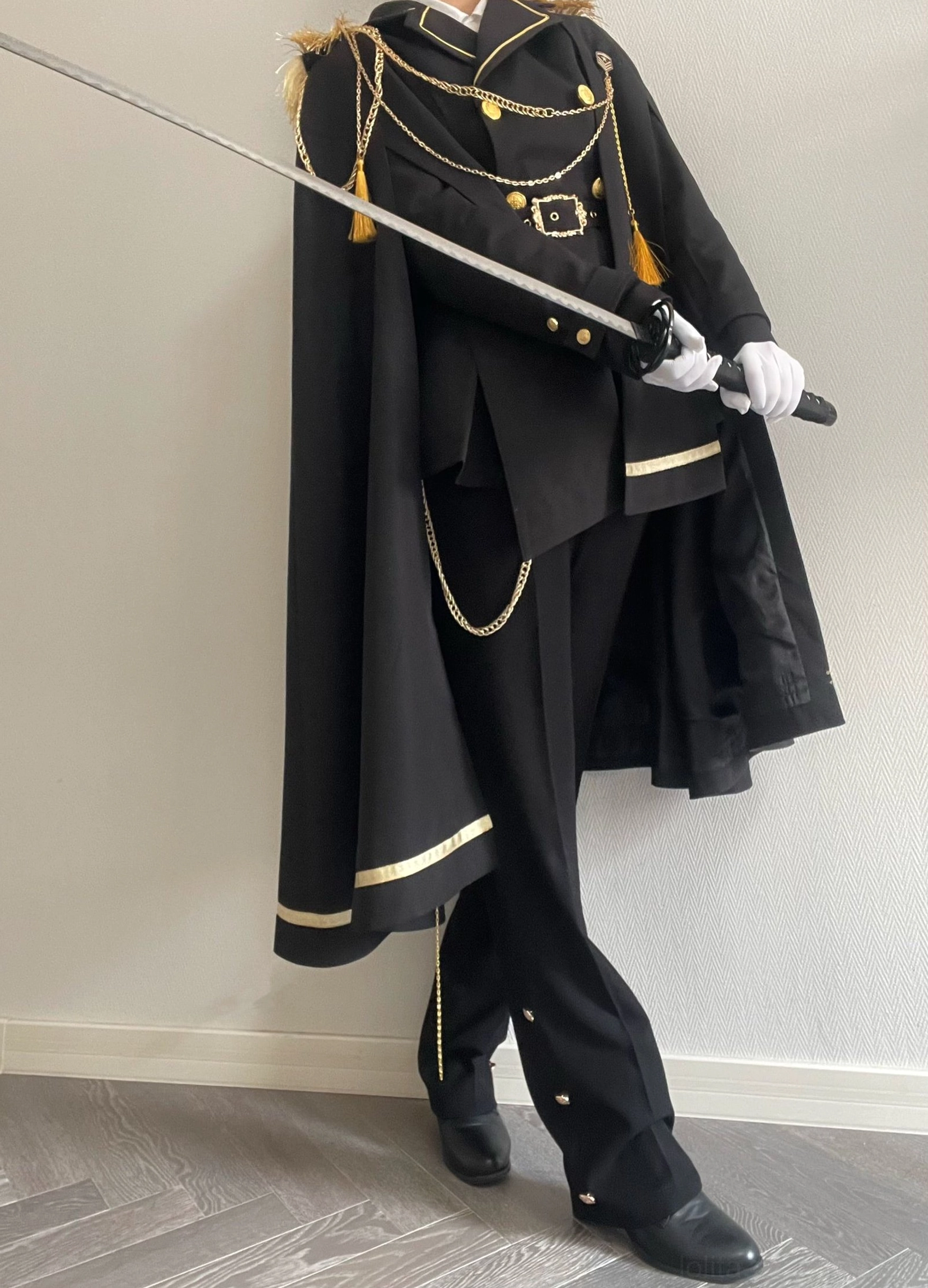 Military Ouji lolita outfit back view showing double-breasted coat structure cape attachment and trouser silhouette
