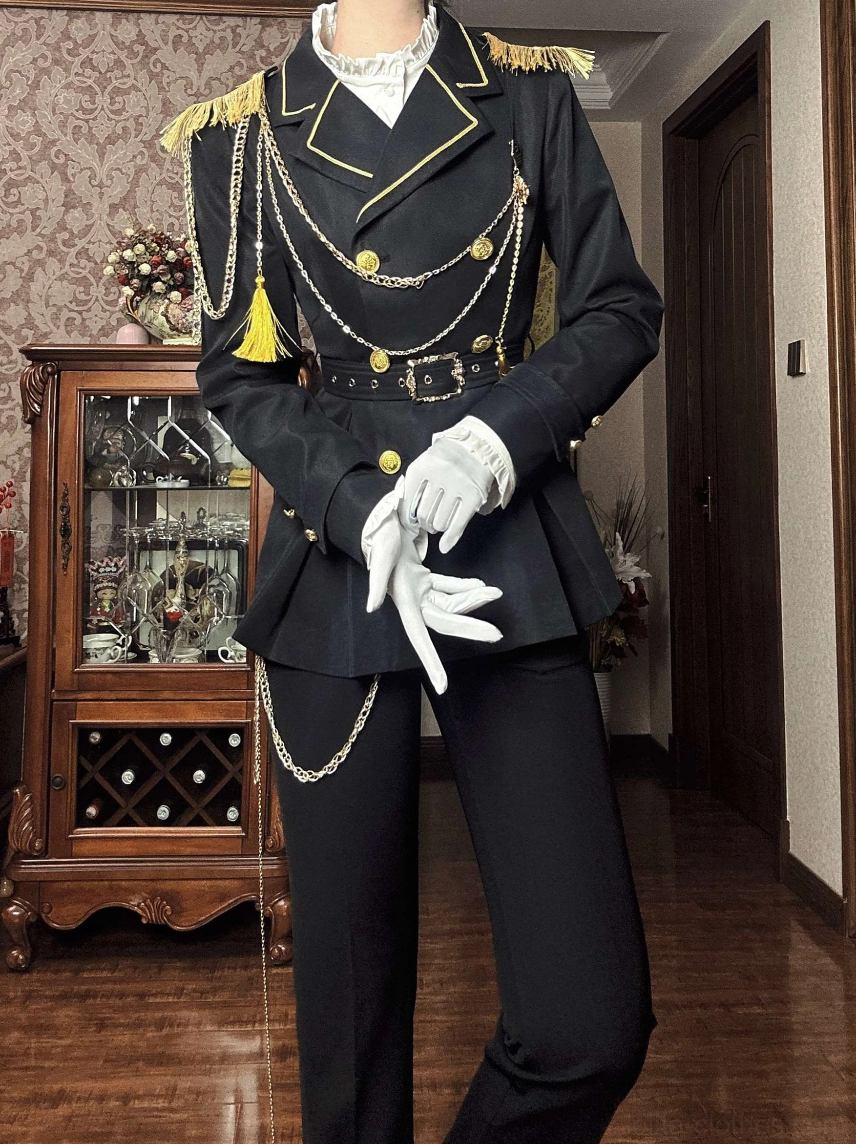 Front facing military Ouji lolita outfit with ruffled white inner collar gold epaulets and multiple chain decorations