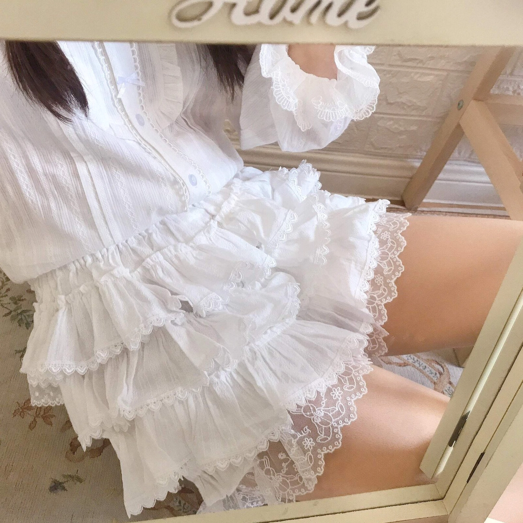 Milk white lolita bloomers showcasing delicate tiered ruffle layers and soft lace trim at leg openings, perfect foundational piece for sweet lolita coordinates