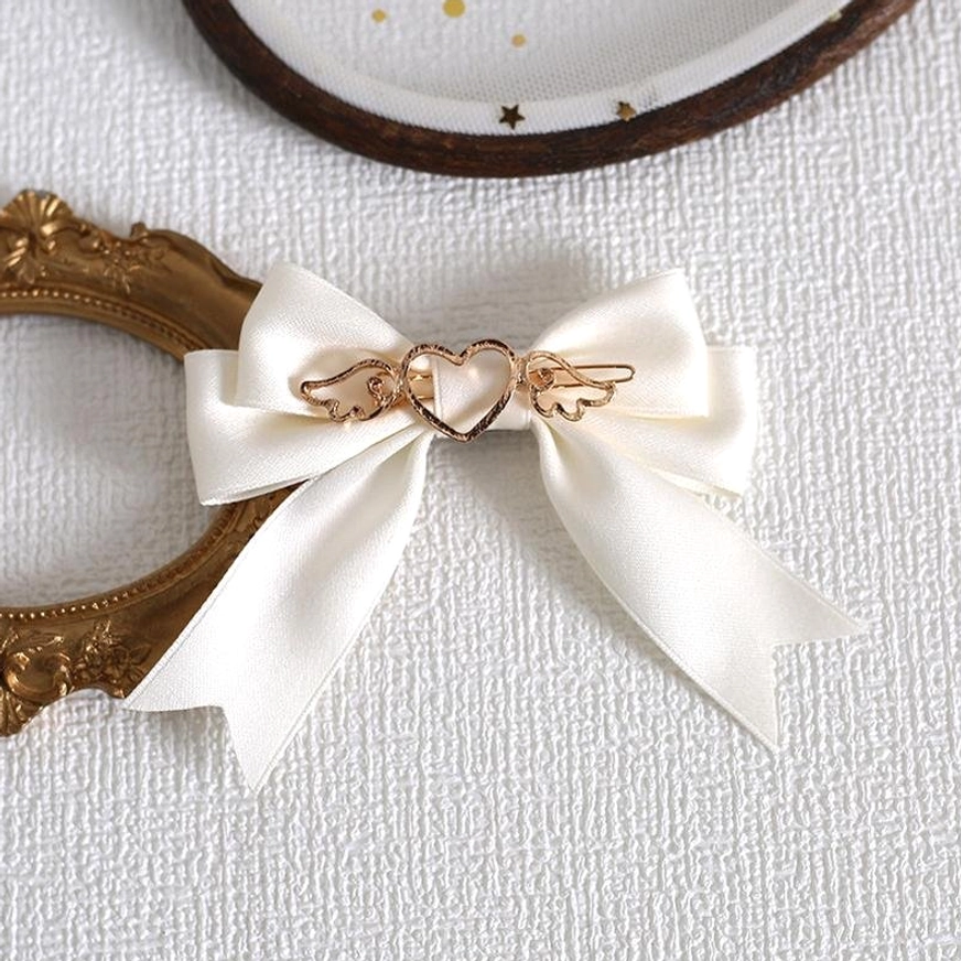 Milky white lolita bow hair clip with gold heart-wing decoration perfect for sweet lolita fashion coordinates