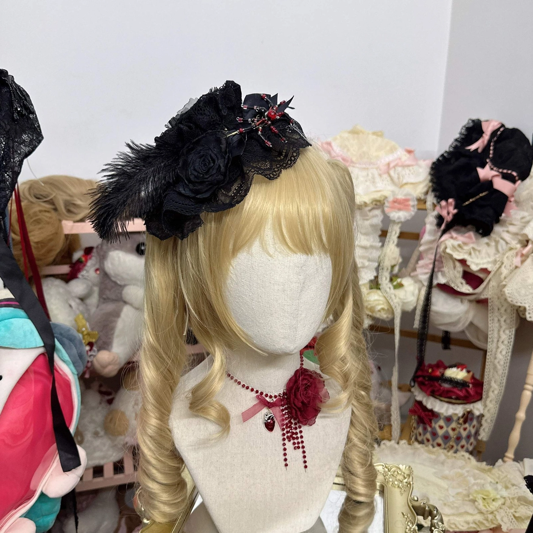 Mini Gothic Lolita hair hat accessory with black rose and feather ornament on blonde wig mannequin