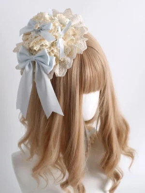 Mini hat style lolita hair clip headdress with layered floral lace and sky blue satin bow accents front view on mannequin
