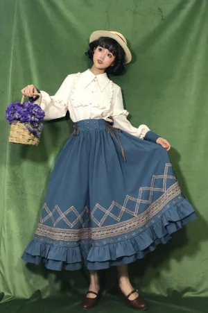 Rural style Lolita SK outfit with blue long skirt ethnic embroidery trim and ruffled hem worn by real model in studio