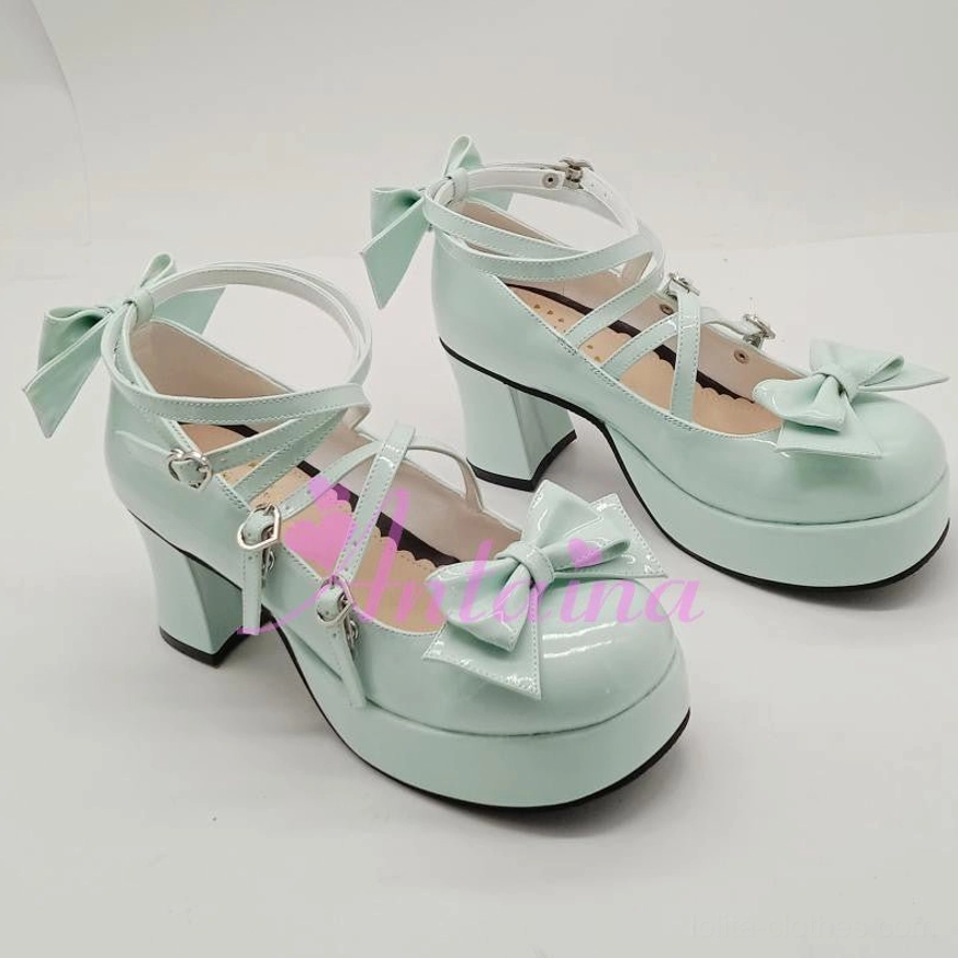 Mint green shining Lolita Mary Jane shoe front view showing dual crisscross straps, bow ornaments, and classic Mary Jane silhouette with platform heel