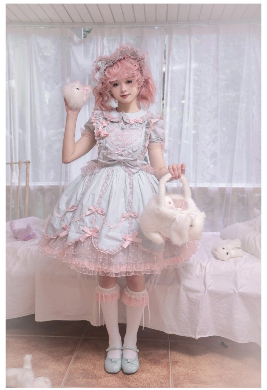 Mint green Lolita jumper dress with petal hem carrying plush basket with pink bow decorations and matching stockings