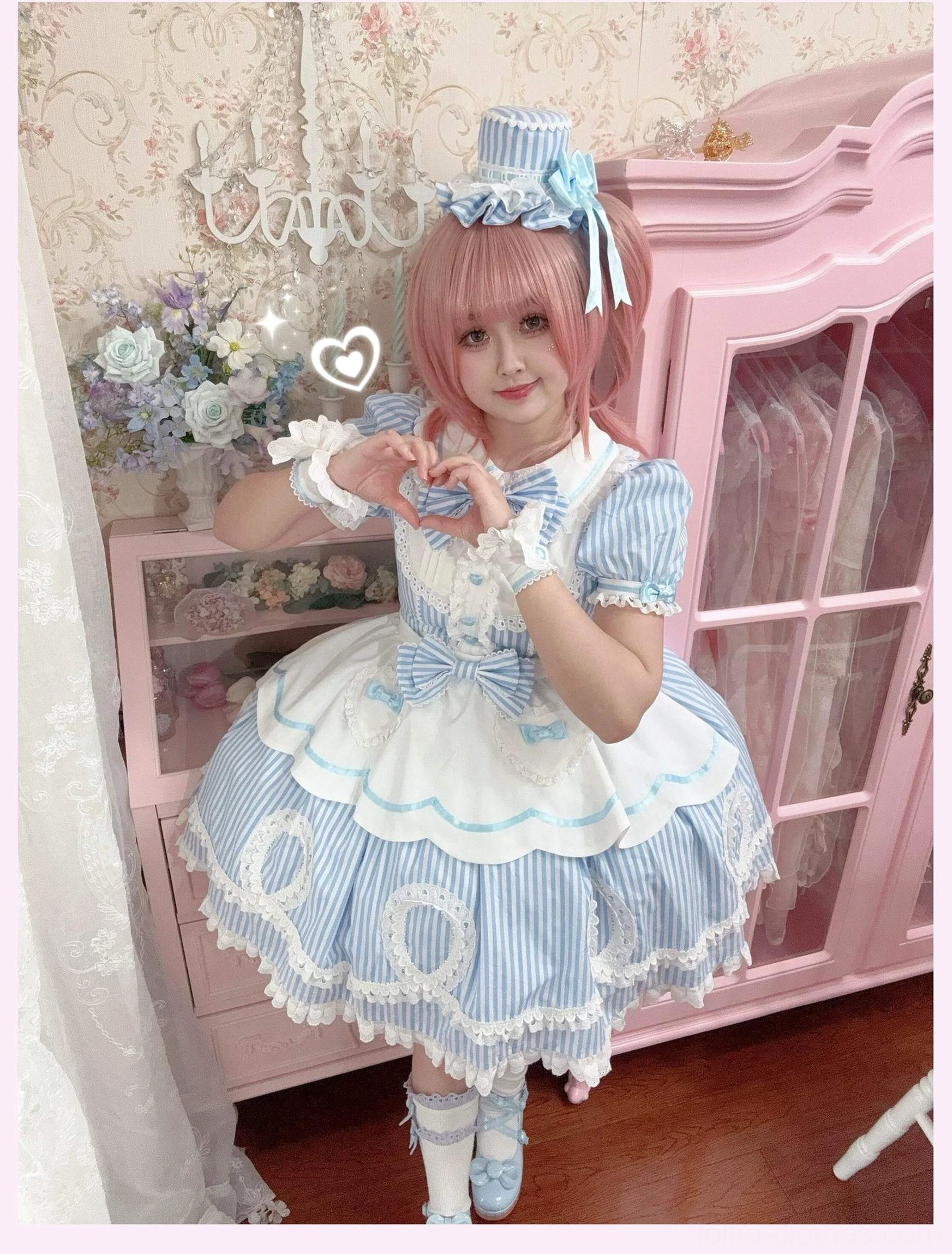 Model in blue striped lolita OP dress with matching blue Mary Jane shoes and coordinated socks