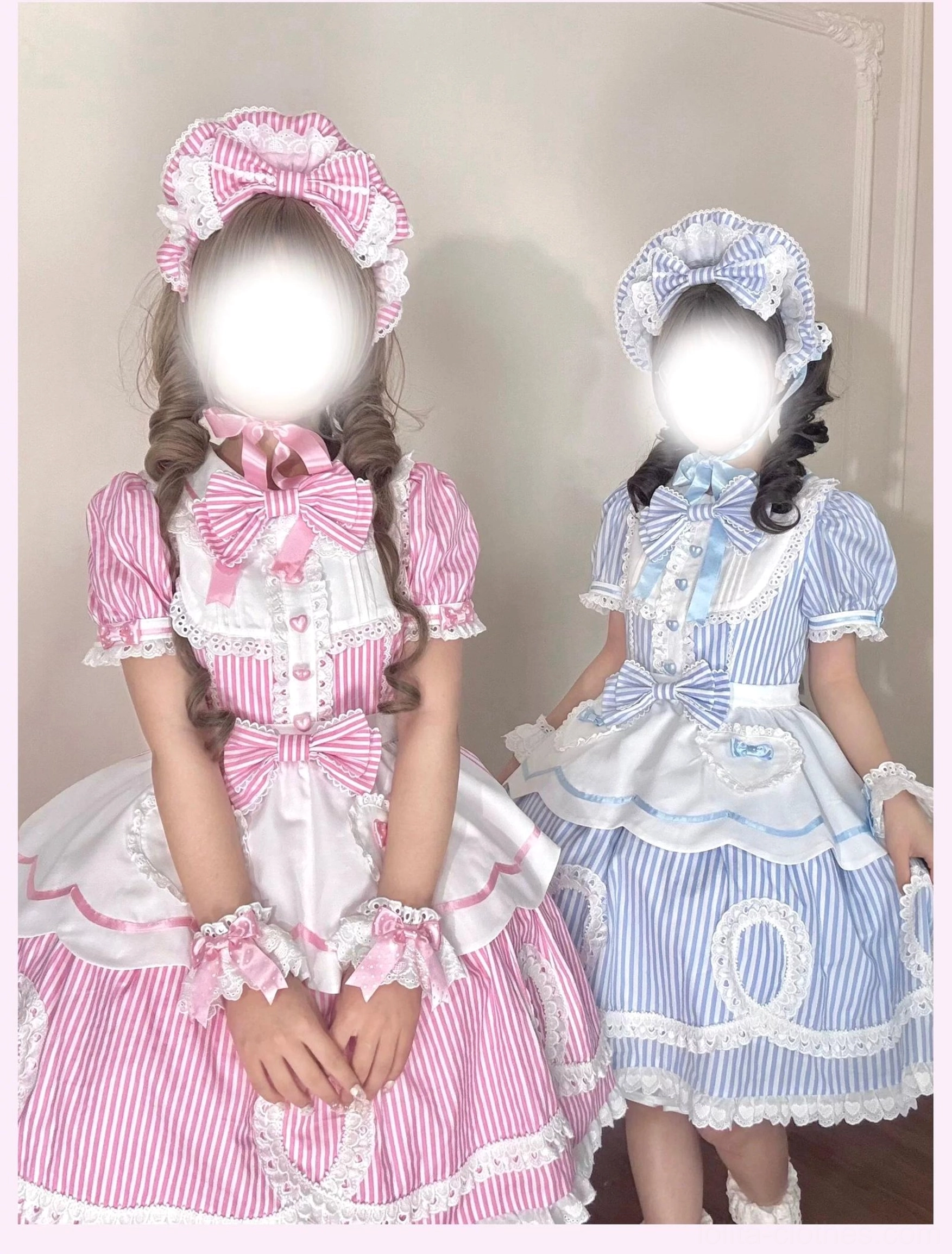 Model posing in blue striped lolita OP dress with twin tail hairstyle and bonnet in vintage room setting