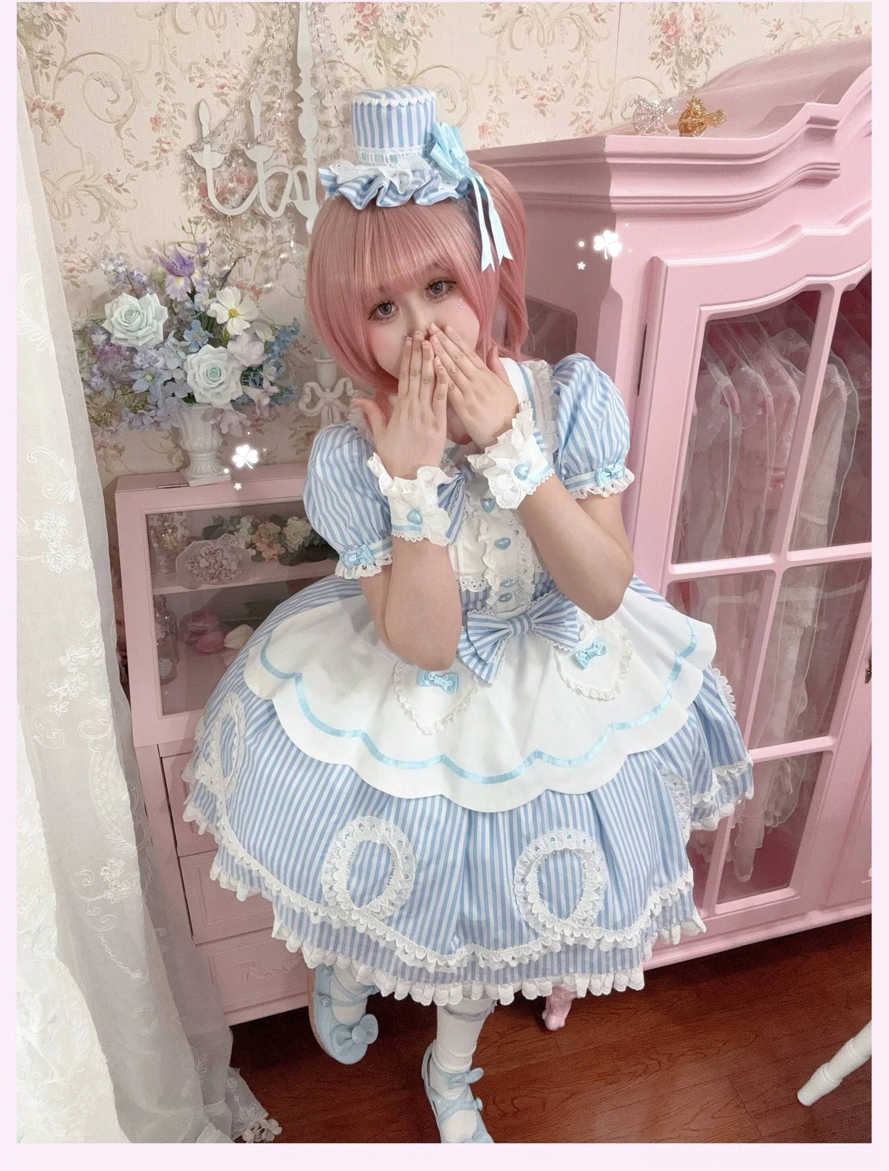 Model twirling in pink striped lolita OP dress showing skirt movement and voluminous design in motion