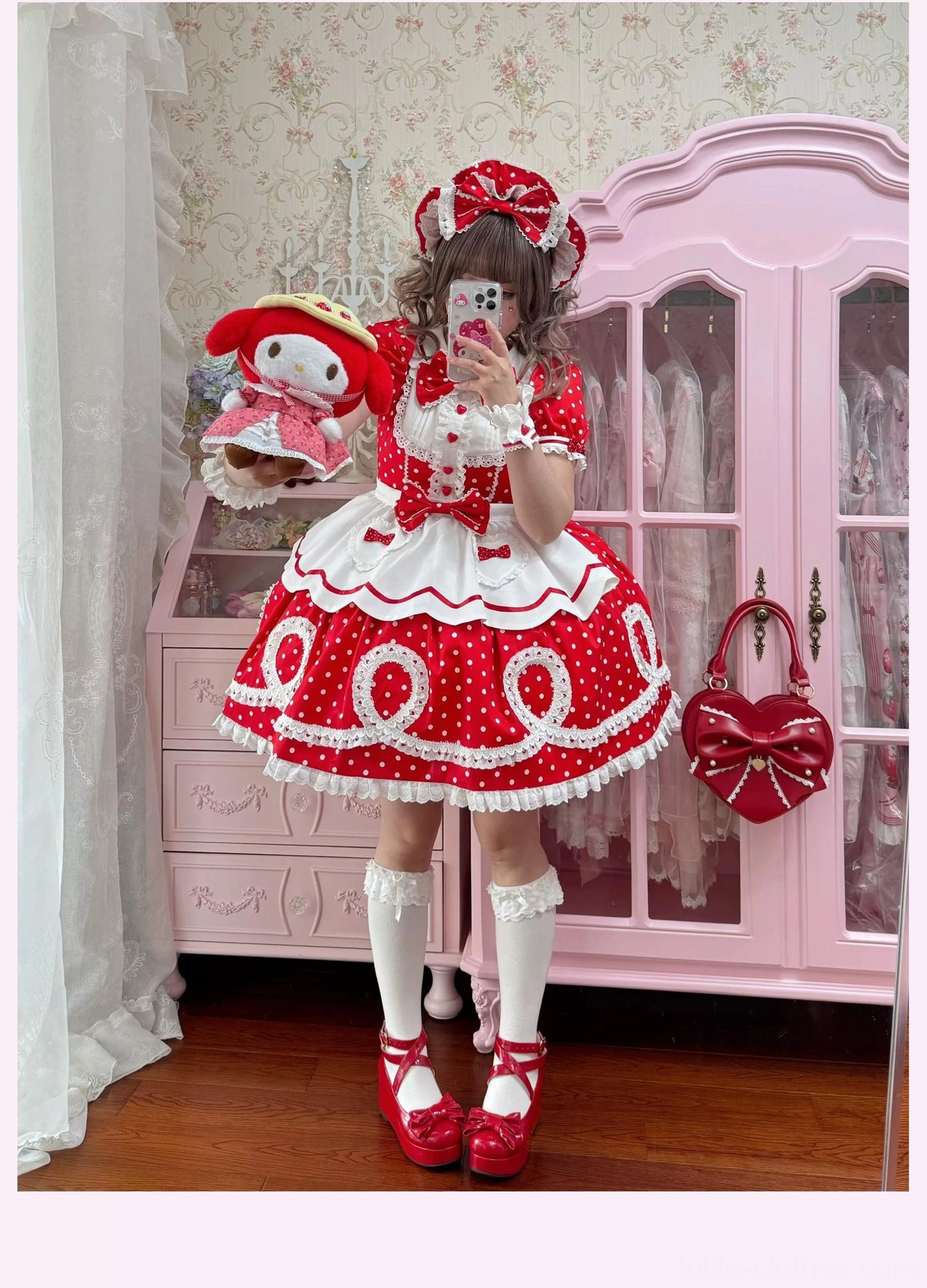 Model wearing pink striped lolita OP dress with detachable apron and bonnet showing complete coordinate styling