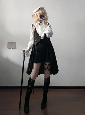 Moonstone Ouji prince black trailing vest full-body front view on blonde model wearing vintage beret, ruffled white blouse, thigh-high boots with leg harness and walking cane in indoor setting