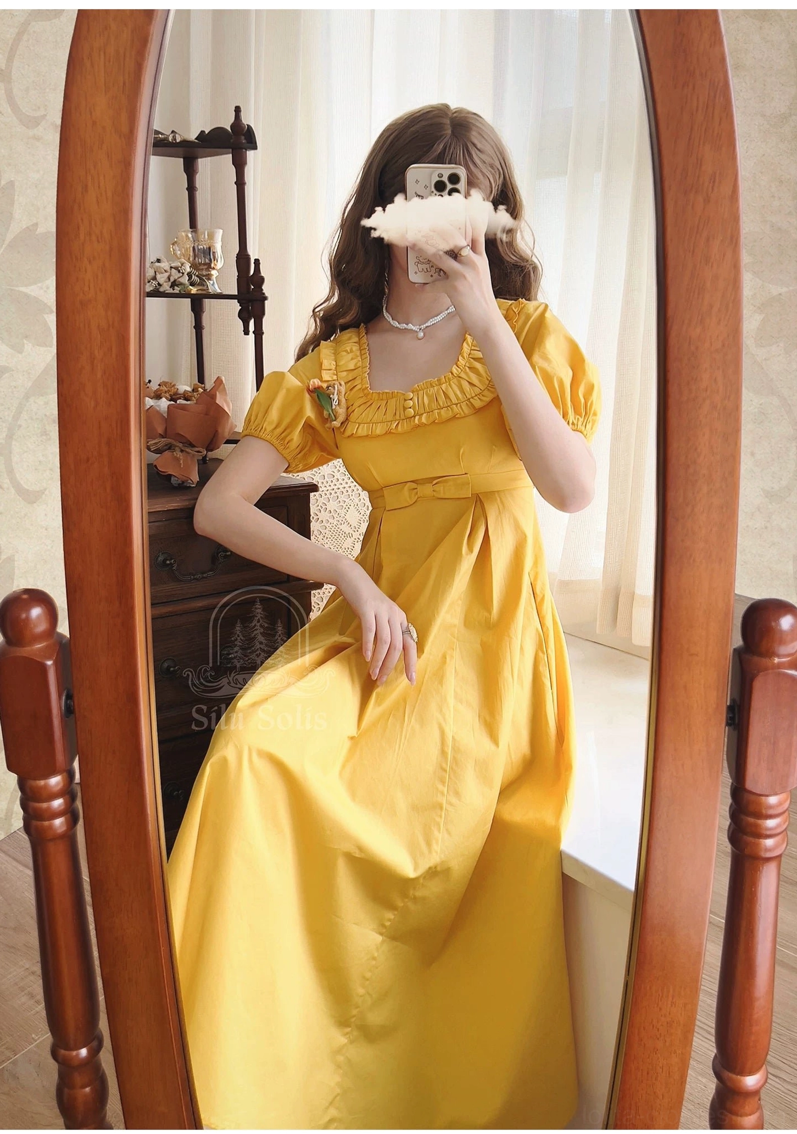 Matcha green lolita empire waist dress waist and A-line skirt detail showing bow accent and smooth cotton fabric