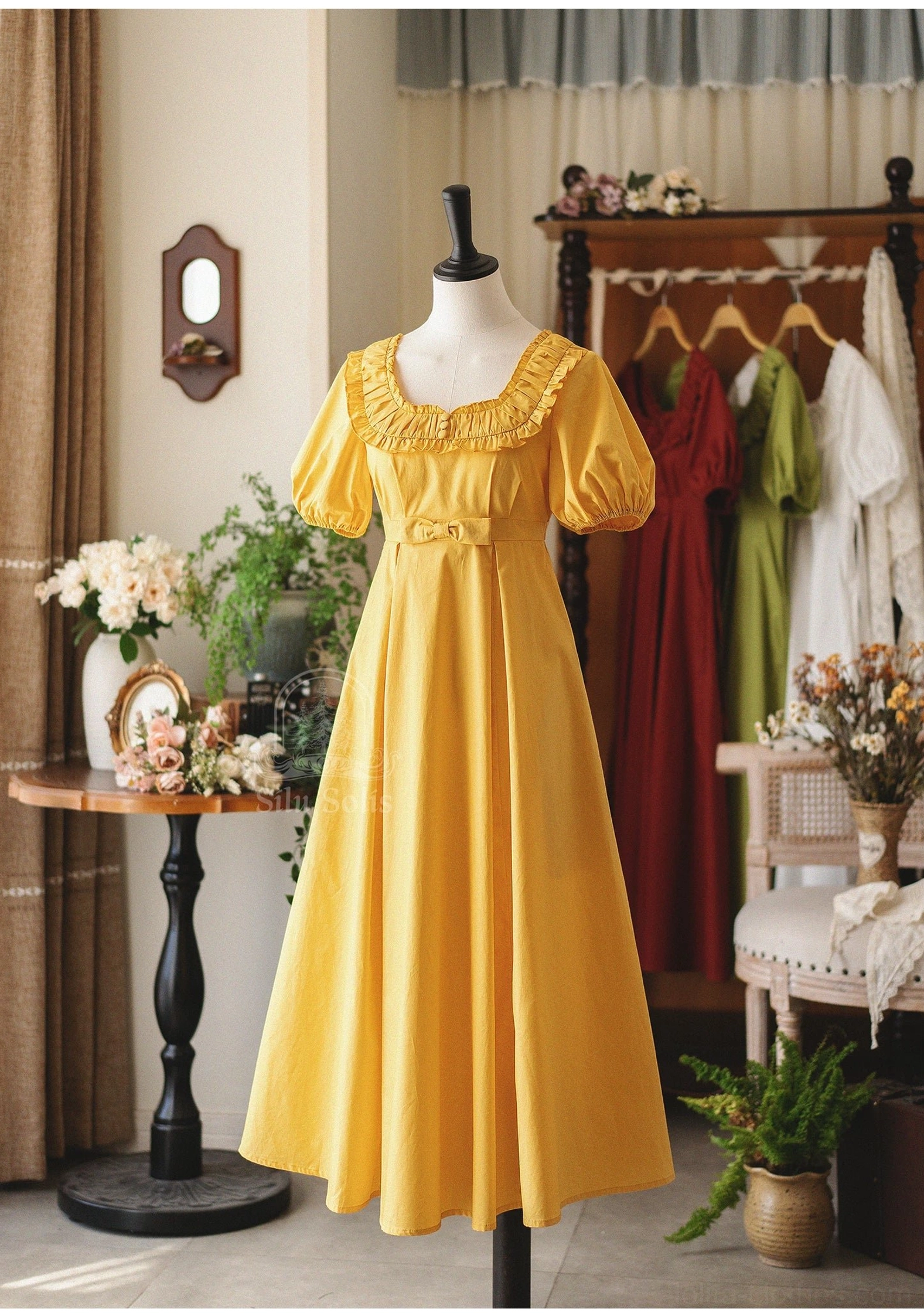 Mustard yellow empire waist lolita cotton dress with decorative waist bow and ruffled neckline on full mannequin display