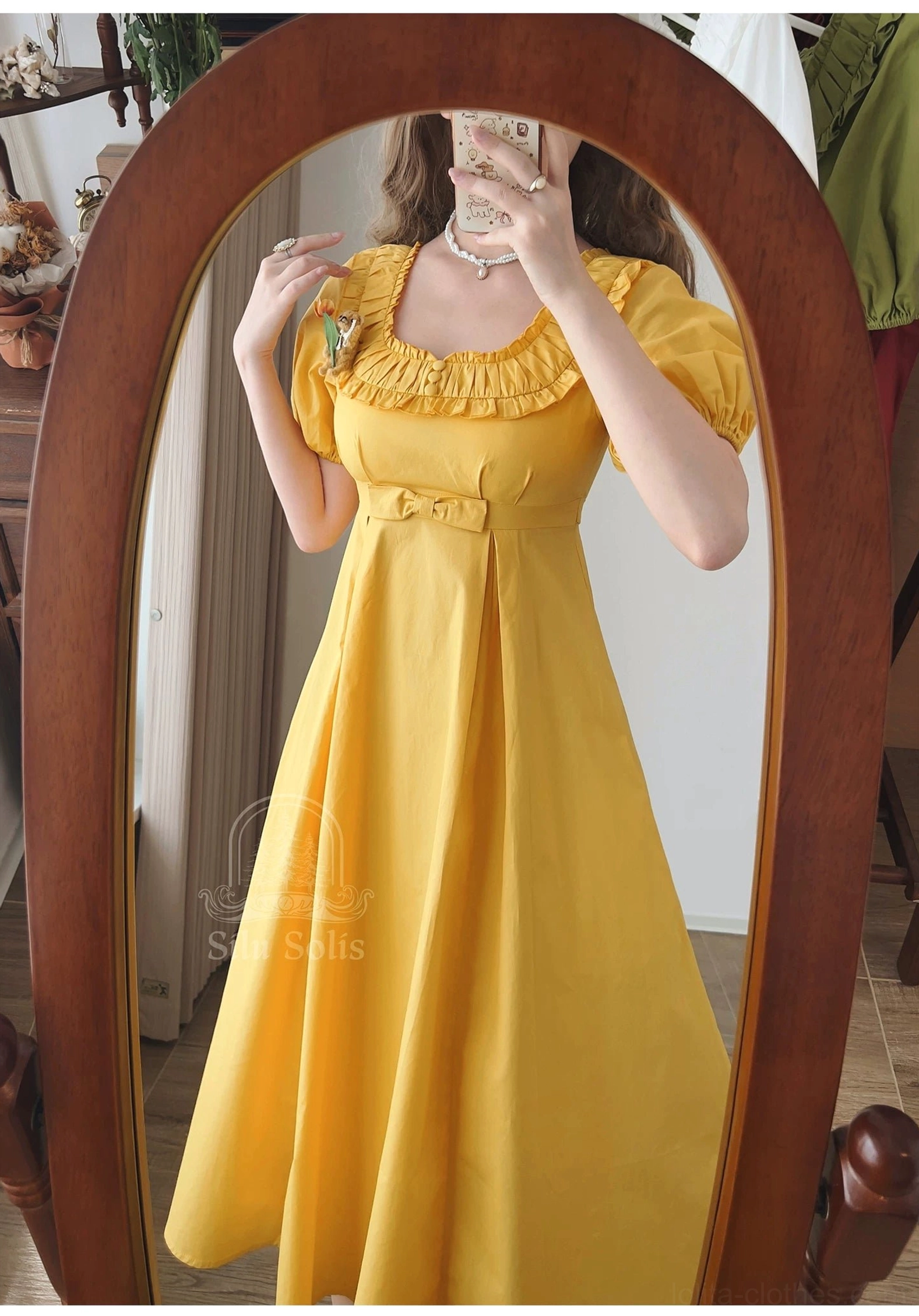 Model wearing mustard yellow lolita empire waist OP dress full body styling shot vintage boutique interior setting