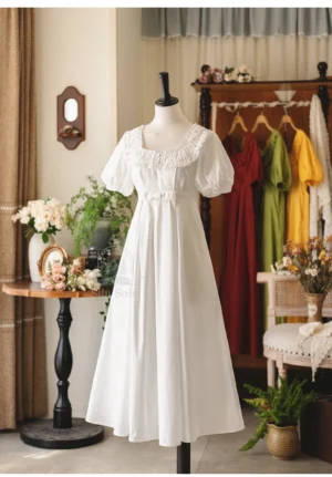 White empire waist lolita one-piece dress with delicate ruffled neckline and puff short sleeves on mannequin full front display