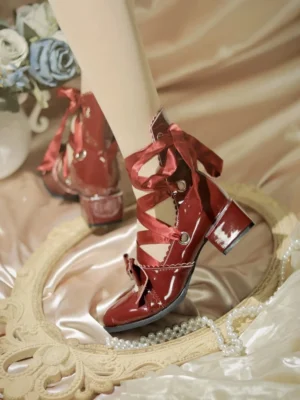 Burgundy lolita lace-up block heel shoes with crisscross satin ribbon laces and ankle bow detail, side three-quarter view highlighting heel construction and elegant silhouette