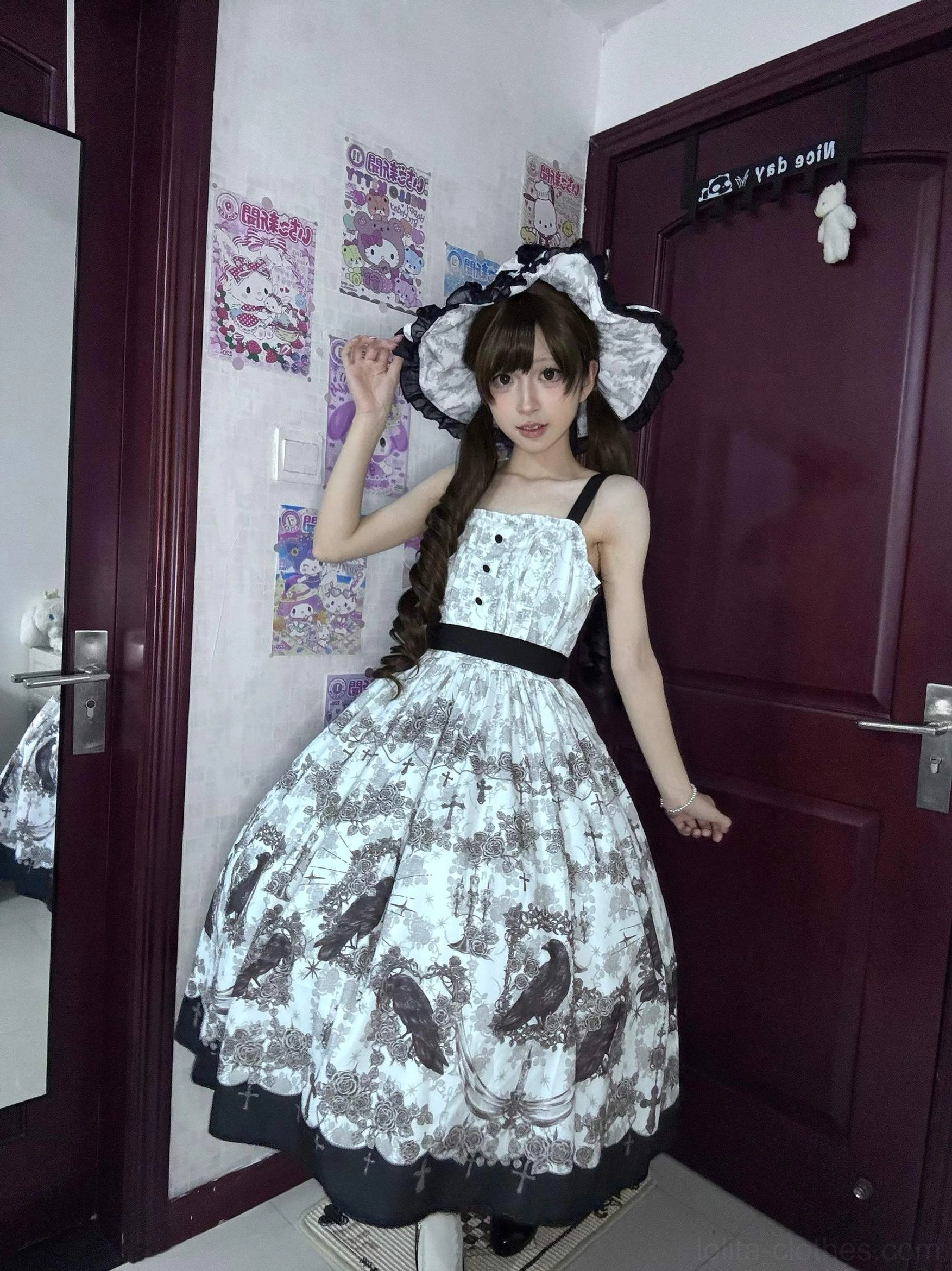 Black gothic lolita sleeveless JSK dress with crow print buttoned bust detail waist sash and full skirt model wearing front view