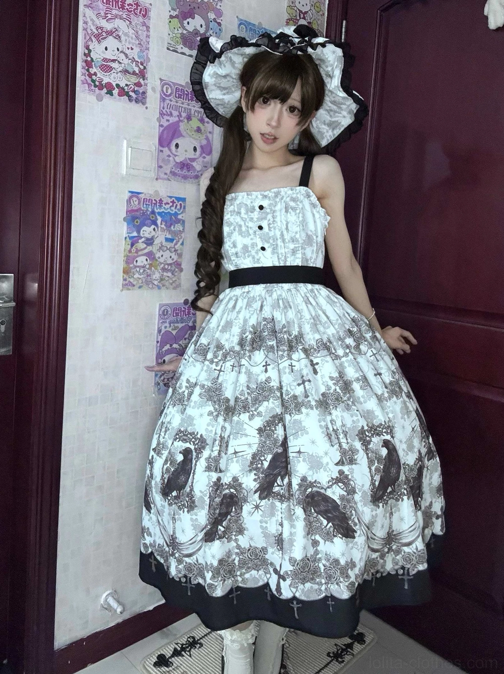Sleeveless gothic lolita JSK jumper skirt with crow print adjustable straps buttoned bodice and black waist sash front three-quarter model view