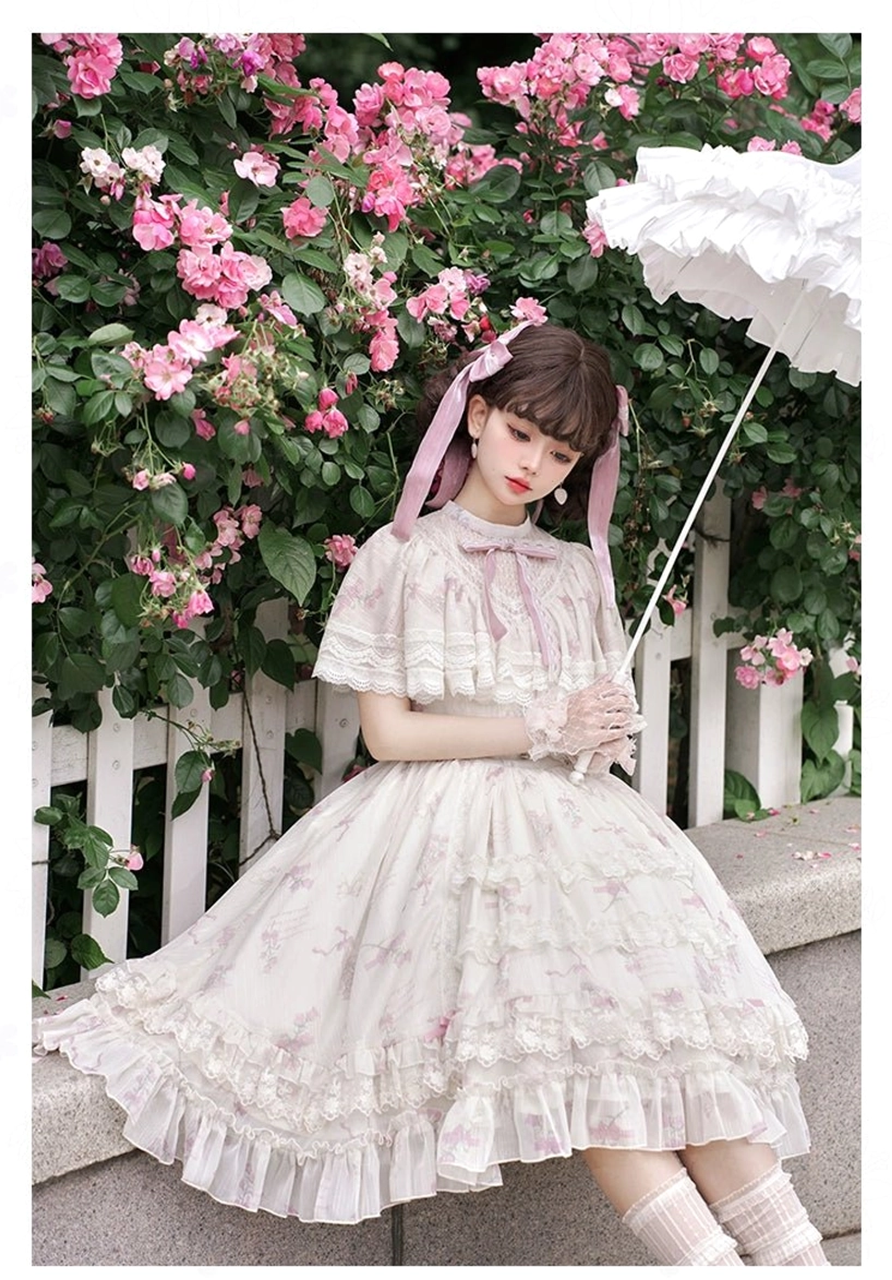 Floral printed lolita OP dress three-quarter sitting view high neckline ruffled short sleeves layered skirt embroidery knee-high pink socks