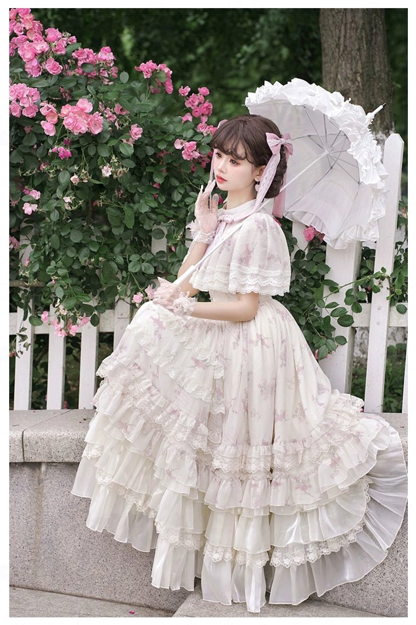 Classic lolita OP dress three-quarter rear view multi-tiered tulle ruffled skirt capelet top light pink floral fabric parasol garden
