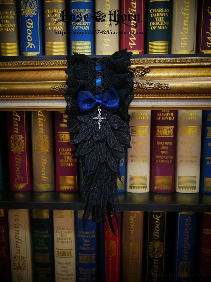 Navy blue plus black gothic lolita headband flat lay on vintage bookshelf background, featuring black lace, custom blue accent, silver cross pendant and wing-shaped tassel applique