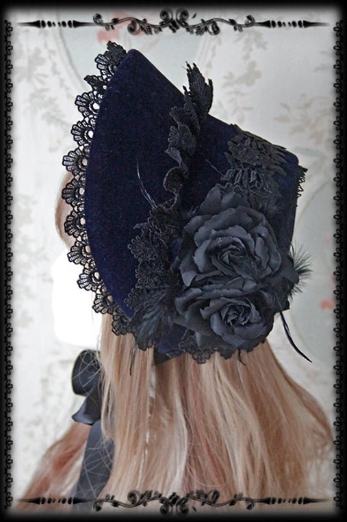 Navy blue Gothic Lolita bonnet with clustered black rose decorations and black lace edging, right rear viewing angle on mannequin