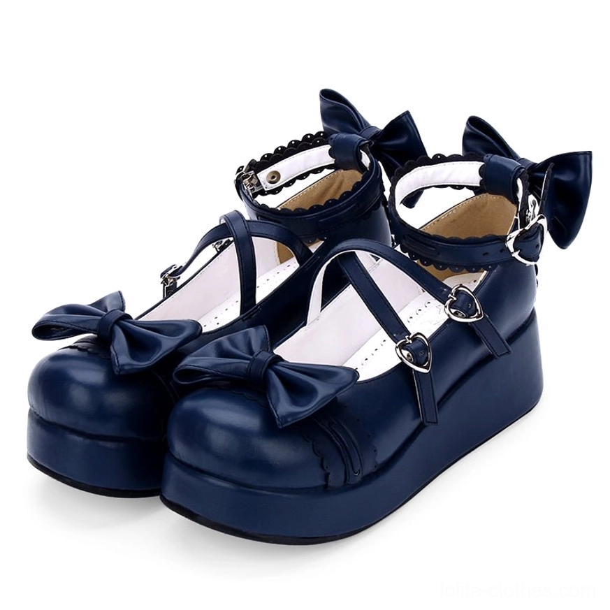 Navy blue sweet Lolita platform Mary Jane shoes three-quarter side view with crisscross ankle straps decorative bows and scalloped collar trim